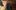 A person looking excitedly up at the stage in the Sam Wanamaker Playhouse