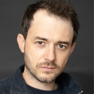 Michael Marcus looking directly at the camera.